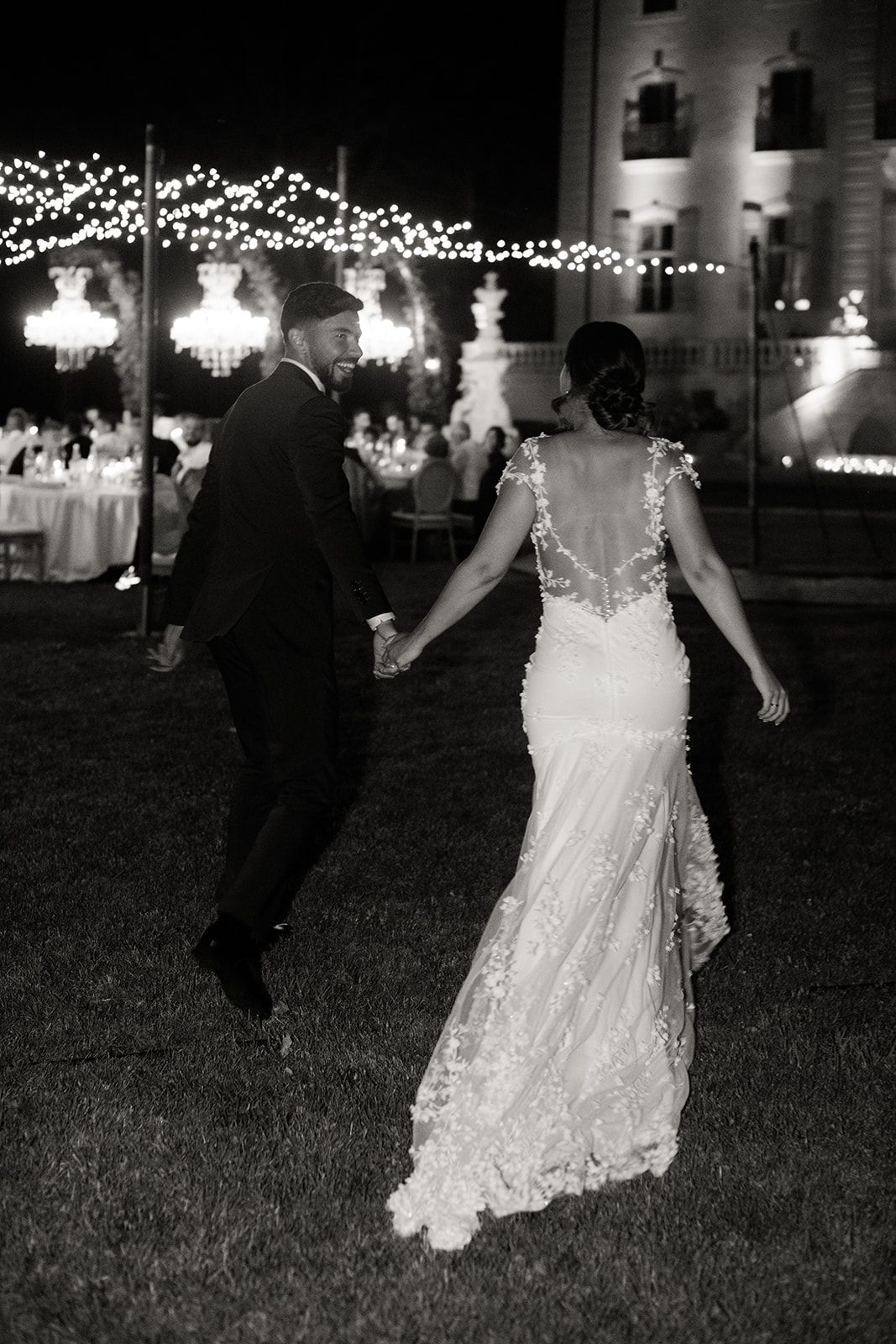 the bride and groom run to their party to join their guests